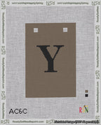 A taped needlepoint canvas with the design: Banner 18 mesh count Squared Y Black on Brown.