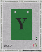 A taped needlepoint canvas with the design: Banner 18 mesh count Squared Y Black on Green.