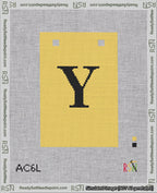 A taped needlepoint canvas with the design: Banner 18 mesh count Squared Y Black on Yellow.