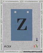 A taped needlepoint canvas with the design: Banner 18 mesh count Squared Z Black on Blue.