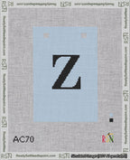 A taped needlepoint canvas with the design: Banner 18 mesh count Squared Z Black on Light Blue.