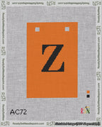 A taped needlepoint canvas with the design: Banner 18 mesh count Squared Z Black on Orange.
