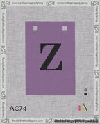 A taped needlepoint canvas with the design: Banner 18 mesh count Squared Z Black on Purple.