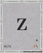 A taped needlepoint canvas with the design: Banner 18 mesh count Squared Z Black on White.