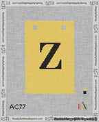 A taped needlepoint canvas with the design: Banner 18 mesh count Squared Z Black on Yellow.