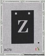 A taped needlepoint canvas with the design: Banner 18 mesh count Squared Z White on Black.