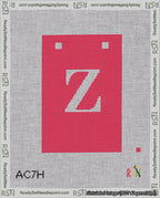 A taped needlepoint canvas with the design: Banner 18 mesh count Squared Z White on Red.