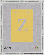 A taped needlepoint canvas with the design: Banner 18 mesh count Squared Z White on Yellow.