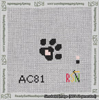 A taped needlepoint canvas with the design: Square Dog Paw Print Black on White with Pink Heart.