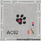 A taped needlepoint canvas with the design: Square Dog Paw Print Black on White with Red Heart.