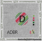 A taped needlepoint canvas with the design: Holiday Circle Initial D Font Black Sans Serif Background Christmas Stripe.